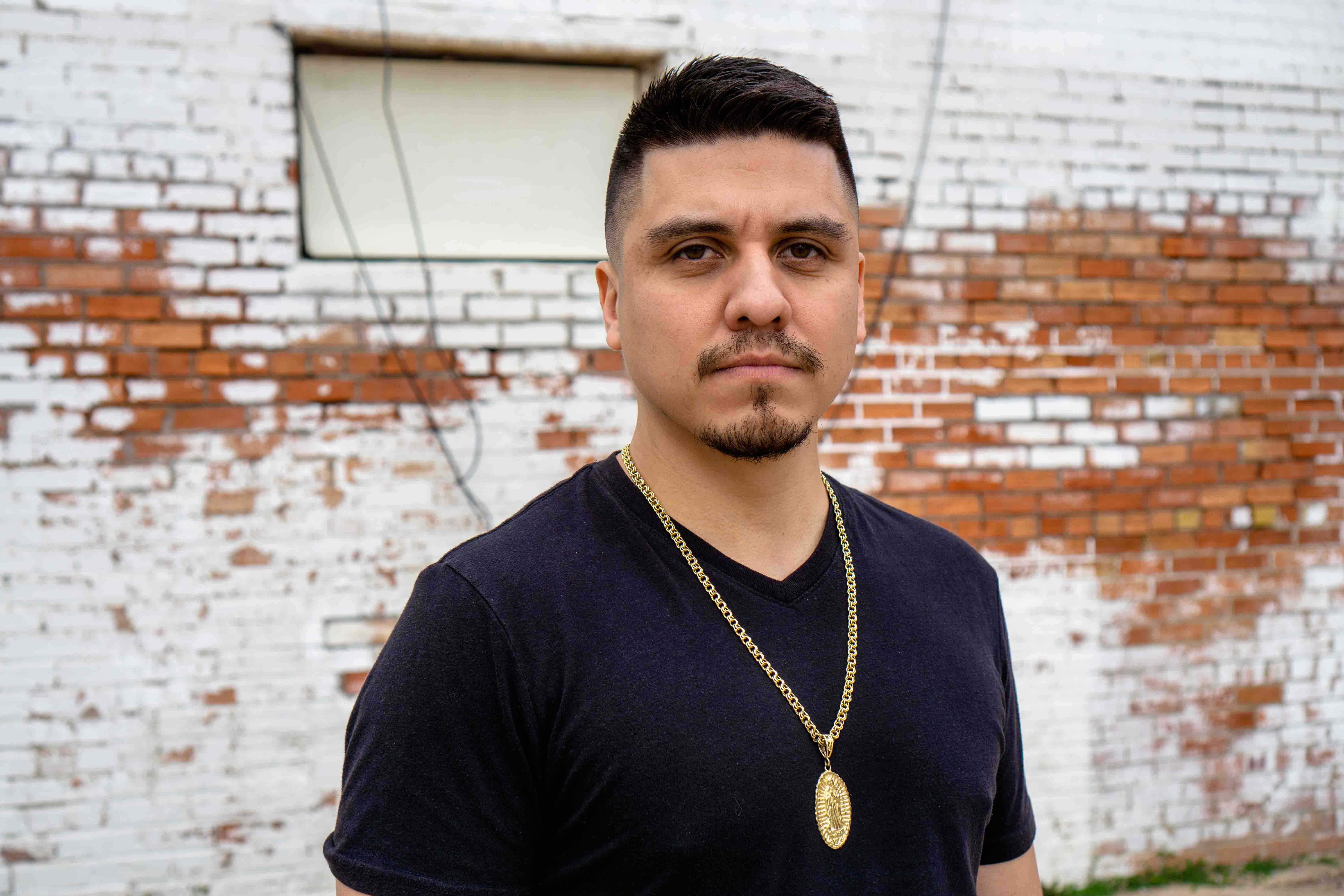 image of author wearing a black shirt with arms crossed