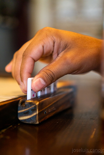 a hand playing a domino