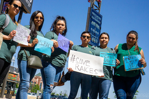 raices members holding a save raices sign