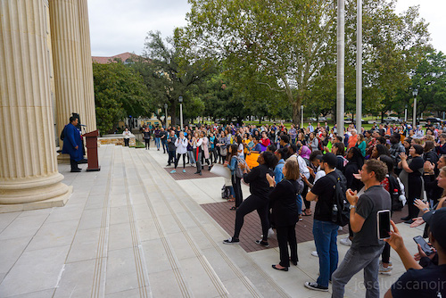 a person speaking in front of a crowd