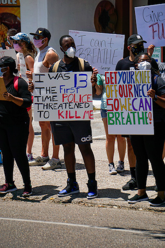 a person holding a sign in protest